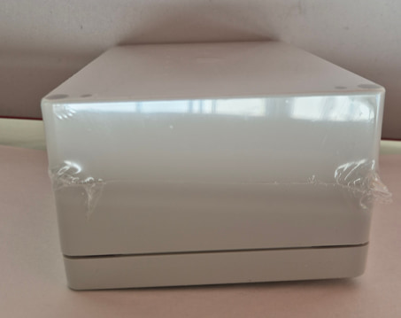 Assembled enclosure shrink-wrapped and foil-finished, ready for dispatch